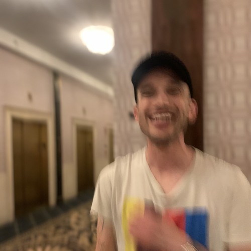 Blurry photo of Nicolas in a hotel hallway 