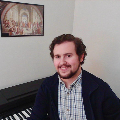 Ethan smiling at a piano