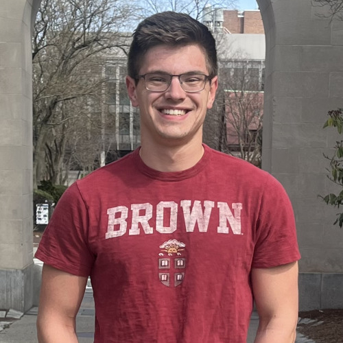 Jacob smiling in a Brown University shirt